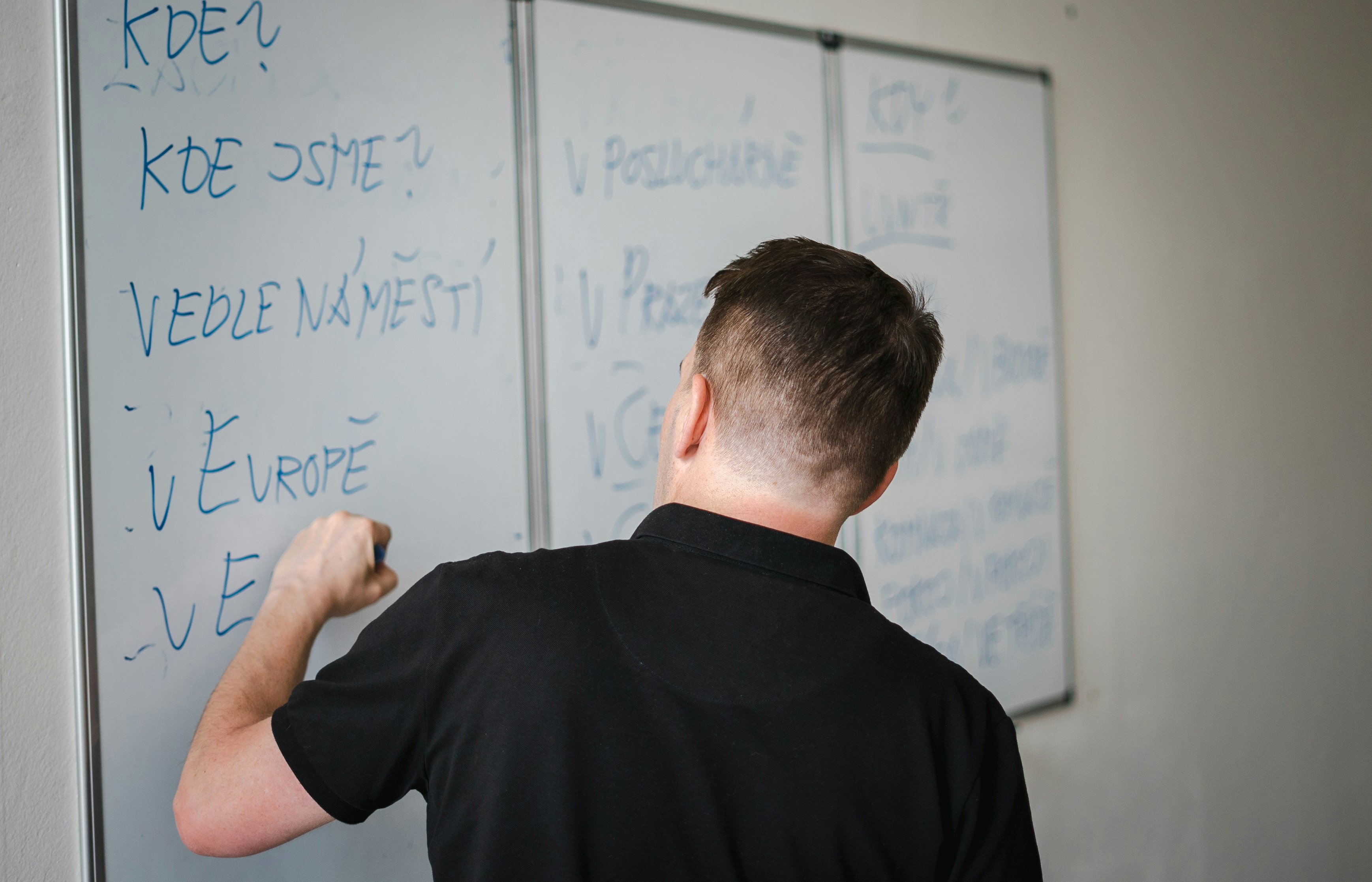 a man writing on a whiteboard